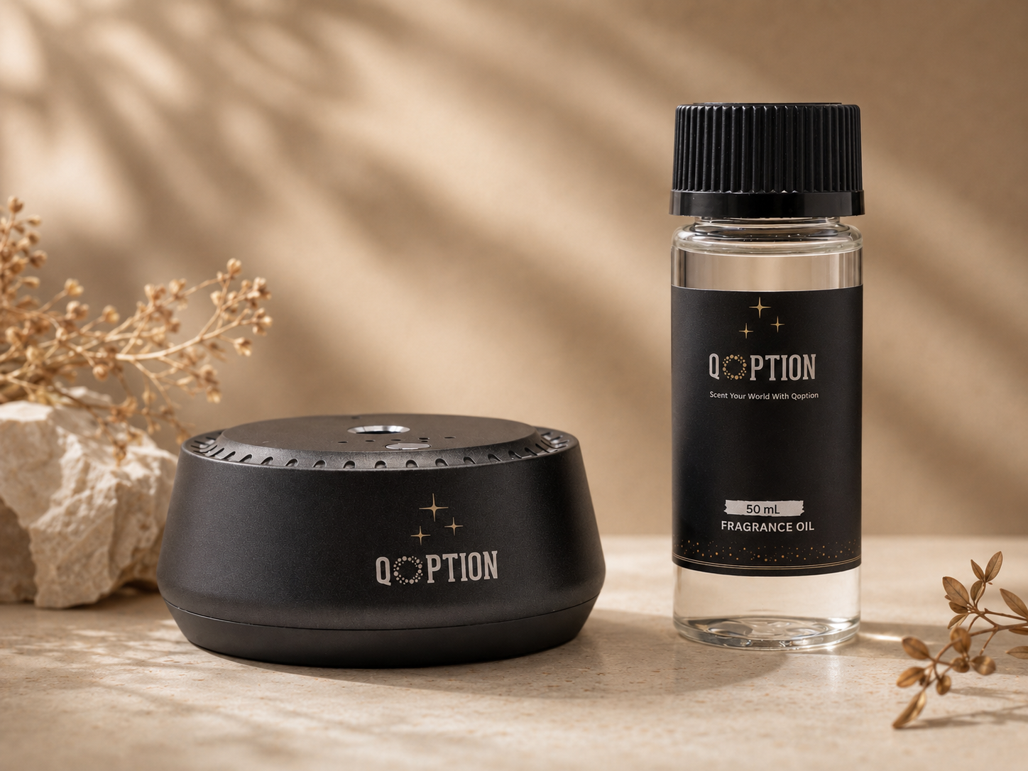 Black 'Qoption' fragrance oil bottle and diffuser on a neutral background