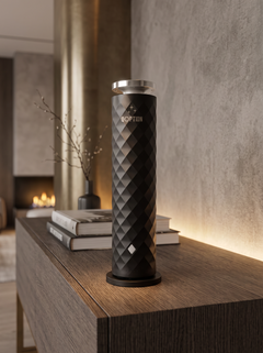QOption Essence QPD10 black cold-air scent diffuser with a textured geometric design on a modern wooden console table.